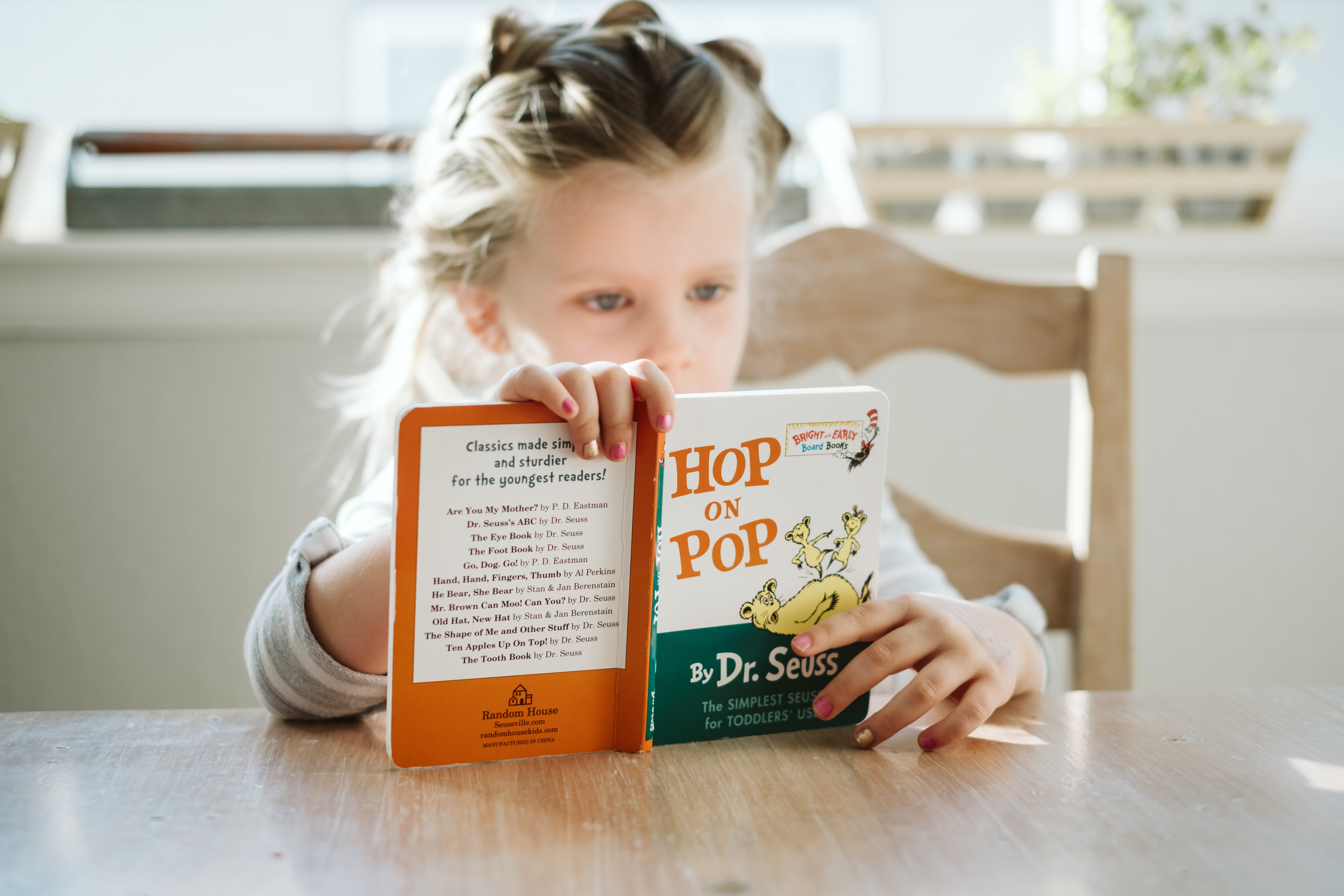 girl sitting while reading book Underrated Dr Seuss Books