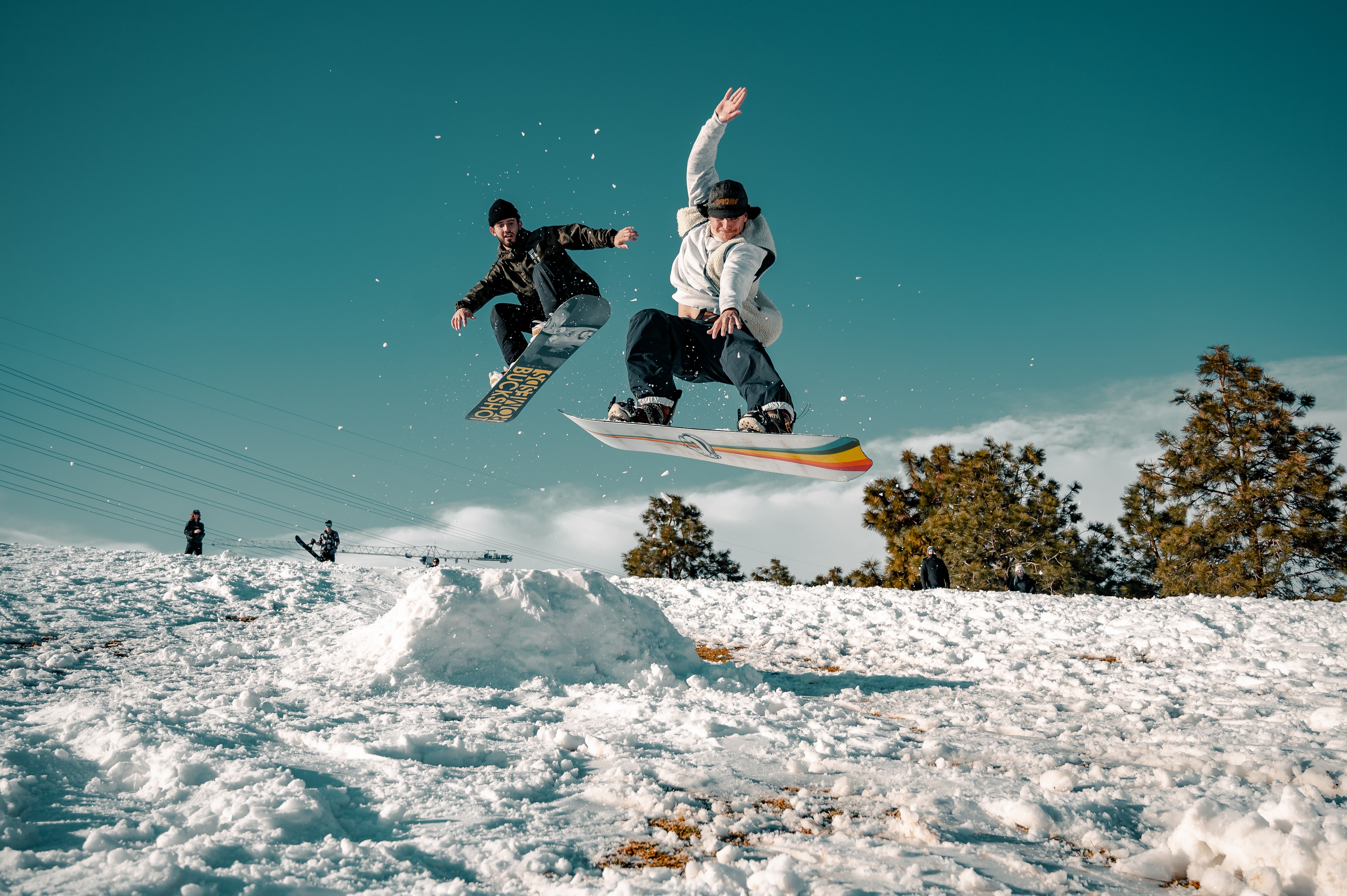 man in black and white jacket riding on snowboard during daytime